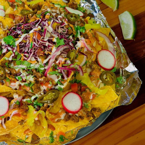 Hermanos Cantina Grill's loaded nachos with ground meat, cheese, jalapenos, radishes, and red cabbage.